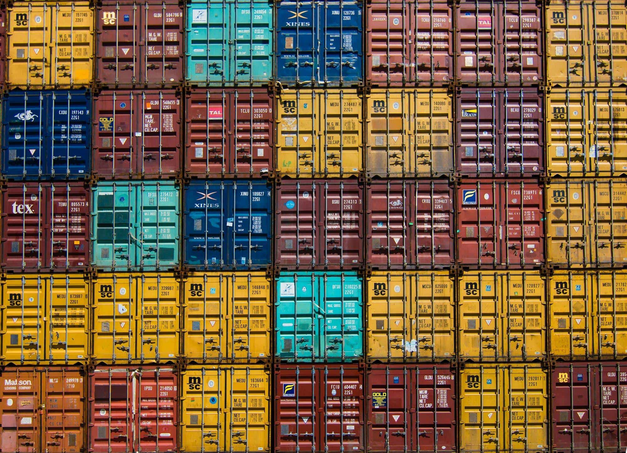 Wall of stacked, colourful shipping containers